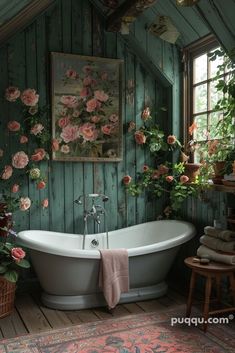 an old fashioned bathtub with flowers on the wall