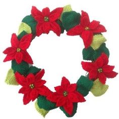 a knitted wreath with poinsettis and green leaves on the front is shown