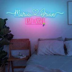 there is a neon sign above the bed