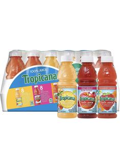 tropical juice is displayed in front of an advertisement for tropical juice, which includes oranges and