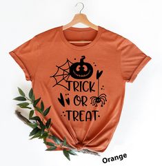 Trick Or Treat Shirts Hi! Welcome to my store, I'm delighted to see you here. My store's main goal is to provide you with premium everyday apparel with the best graphic t-shirts.  DESCRIPTION *Printed and shipped from the USA. *We use state of art printing on soft and quality shirts. *Different size options; crewneck, youth, women's v-neck, toddler, and baby size options.  *Effective customer service and expedited shipping.  *Solid colors are 100% airlume combed and ringspun cotton.  *Heather co Funny Halloween T-shirt With Character Print, Halloween Novelty T-shirt With Graphic Print, Halloween Themed Short Sleeve Shirt, Themed Halloween Short Sleeve Shirt, Orange Halloween T-shirt With Letter Print, Fun Halloween T-shirt Pre-shrunk, Funny Halloween Character Print T-shirt, Funny Halloween T-shirt With Screen Print, Fun Halloween Pre-shrunk T-shirt