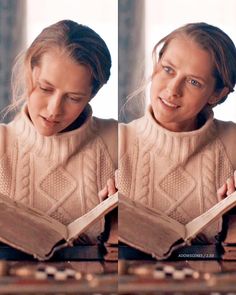 a girl is reading a book while wearing a sweater