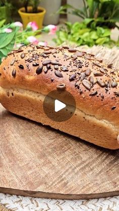 a loaf of bread sitting on top of a wooden cutting board