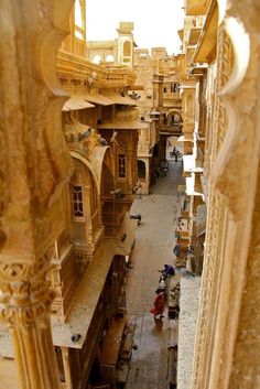 an aerial view of the inside of a building with people walking around and sitting on benches