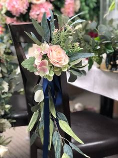 a bouquet of flowers sitting on top of a wooden chair