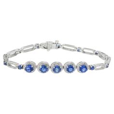 This elegant 18KT white gold bracelet features a total of 3.00CT of round-cut genuine Ceylon blue sapphires, adding a vivid and captivating touch. The sapphires are beautifully complemented by 1.56 carats total weight of G-VS/SI round-cut diamonds, set in the finest 18KT white gold. This combination of vibrant blue sapphires and sparkling diamonds creates a sophisticated and luxurious accessory, making it a timeless addition to any jewelry collection. Timeless Blue Round Bracelets, Luxury Sapphire Diamond Round Bracelet, Sapphire Diamond Tennis Bracelet With Round Cut, Sapphire Diamond Tennis Bracelet With Round Shape, Sapphire Tennis Bracelet With Round Diamonds, Luxury Sapphire Diamond Bracelet, Sapphire Brilliant Cut Tennis Bracelet, Classic Sapphire Tennis Bracelet With Brilliant Cut, Classic Round Sapphire Diamond Bracelet