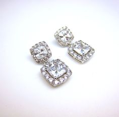 AAA cubic zirconia diamond square shape drop. Sparkling square cubic zirconia deco white gold plated metal frame post earrings.earrings have Emerald cut & Cubic Zirconia framed in micropave to look like real diamonds! Posts are sterling silver. Size: 2.7cm x 1.3cm Matching bracelet: https://www.etsy.com/listing/175833758/wedding-jewelry-bridesmaid-jewelry?ref=shop_home_active_7&ga_search_query=bracelet Matching necklace: https://www.etsy.com/listing/177502034/wedding-necklace-bridal-neck Bridal Wedding Earrings, Wedding Bridesmaid Jewelry, Jewelry Bridal, Clear White, Earrings Wedding, Square Earrings, Matching Bracelets, Matching Necklaces, Bridesmaid Jewelry