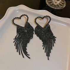 Crystal Heart Earrings With Rhinestones For Party, Glamorous Rhinestone Heart Earrings For Party, Gold Heart Shaped Crystal Earrings For Party, Trendy Black Metal Heart Earrings, Black Rhinestone Fringe Jewelry For Party, Party Black Rhinestone Fringe Jewelry, Party Black Jewelry With Rhinestone Fringe, Black Heart Drop Earrings For Party, Crystal Heart Drop Earrings For Party