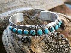 This is a beautiful Handcrafted Native American Made Sterling Silver Turquoise Gemstone Bracelet Cuff. The cuff is entirely Handcrafted which makes it a ONE OF A KIND. You get the EXACT bracelet shown. (It will come Gift Boxed) This piece is stamped Sterling and also has the name of the Native American artist silversmith. P Yazzie (Patrick Yazzie) is known for his Native American works of art.  With it's beautiful Turquoise and it's Oxidized Sterling Silver and Hand Stamped Native American design this unique bracelet would make a great gift or add it to your collection! It can be for a man or woman. In the Native American culture it is believed that Turquoise jewelry is a symbol of protection, truth, and courage. It is also believed to have the power to repel negativity energy and deflect Turquoise Sterling Silver Bracelet For Anniversary, Turquoise Sterling Silver Bracelets For Anniversary, Turquoise Stamped Bangle, Engraved Turquoise Sterling Silver Bracelet Gift, Stamped Turquoise Bracelet, Southwestern Blue Cuff Bracelet As Gift, Turquoise Stamped Bracelet, Engraved Turquoise Jewelry Bracelet, Engraved Turquoise Bracelet Jewelry