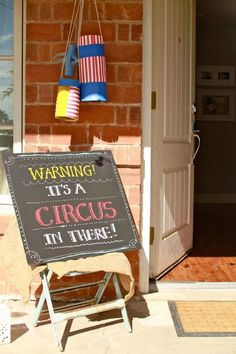 a sign that says warning it's a circus at there on the front porch