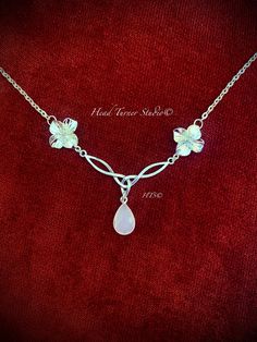 Elegant Handmade Silver Moonstone Rhodium Plumeria Flower Celtic Love Knot Choker or Necklace Perfect for your wedding or anytime you want to feel beautiful! ∞༺♥༻∞ ✨P R O D U C T I O N - T I M E ✨ Each of my lovingly handcrafted pieces is naturally one of a kind and hand made to order. Please allow 1-3 business days for production. If you have a specific deadline, please let me know and I will do my best to accommodate you!   ✨C A R E - I N S T R U C T I O N S ✨ Each of my creations is hand crafted with love, intention, and meticulous attention to detail, aesthetic, and durability. Please note, however, that some materials are naturally fragile and may develop a patina, which is part of the charm. Handling your jewelry with care is recommended. Please keep your jewelry dry to protect the f Whimsical Sterling Silver Wedding Jewelry, Adjustable Necklace With Flower Charm For Wedding, Delicate Necklaces For Wedding On Valentine's Day, Adjustable Flower Charm Necklaces For Wedding, Adjustable Necklaces With Flower Charm For Wedding, Adjustable Flower Charm Necklace For Wedding, Delicate Wedding Necklaces For Valentine's Day, Adjustable Flower Pendant Necklace For Wedding, Adjustable Wedding Flower Necklace With Charm