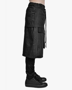 ‘- Black in color – Asymmetrical cut layers – Elastic waistband with drawstrings in black – Cargo construction and utility pockets – Front single welt pocket with visible bag – Front patch zip YKK Excella pocket – Side pleated patch flap pocket in signature pattern – Rear single welt pocket – Tonal stitching All Black High Fashion, Mens Skirt, Black High Fashion, Single Welt Pocket, Cut Layers, Asymmetric Skirt, Asymmetrical Cut, Utility Pockets, Black Cargo