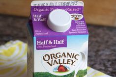 a carton of organic valley milk sitting on a counter top next to a napkin