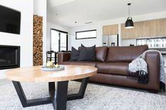 a living room filled with furniture and a flat screen tv mounted on the wall next to a fire place