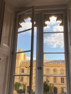 an open window with the view of a castle