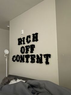 there is a black and white sign that says high off content on the wall in this bedroom