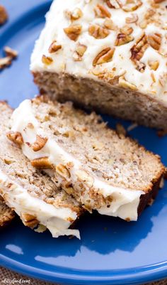 slices of banana bread on a blue plate with pecans scattered around the whole loaf