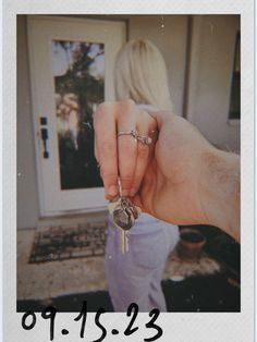 a person holding a key to their house