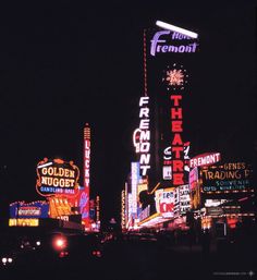 the neon signs are all lit up at night