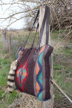 Restocked! Handwoven of imported 100% wool in classic Zapotec styles and rich colors. This handcrafted handbag is a Southwest style favorite. Zipper closure, fully lined inside, interior pocket and racoon tail embellishment.Apx. 15" x 18" Handcrafted Handbags, Mayan Riviera, Southwest Style, Racoon, Rich Colors, Rich Color, Duffle Bag, Hand Weaving, Purse