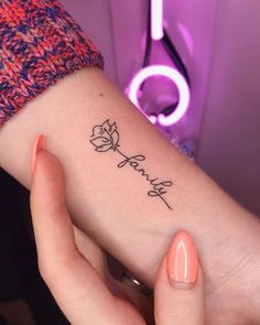 a woman's arm with a rose tattoo on the left side of her wrist