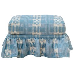 a blue and white checkered ottoman with ruffles on the bottom, sitting in front of a white background