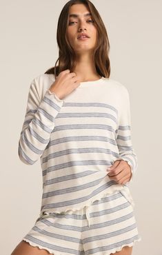 Meet your new lounge essential: a dropped shoulder, crew neck long sleeve top crafted from irresistibly soft slub sweater knit fabric. Embrace laid-back comfort with its relaxed fit and chic stripe pattern, perfect for lounging in style all day. Knit Long Sleeve Tops With Striped Hem, Everyday Striped Long Sleeve Sweater, Striped Long Sleeve Sweater For Loungewear, Striped Long Sleeve Sweater For Everyday, Crew Neck Tops With Striped Hem, Crew Neck Tops With Striped Hem For Layering, Cozy Striped Long Sleeve Top, Striped Long Sleeve Soft Knit Top, Long Sleeve Tops With Striped Hem For Layering