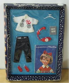 a doll in a box with clothes and accessories for it's birth or birthday