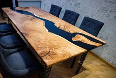 a large wooden table with blue chairs around it