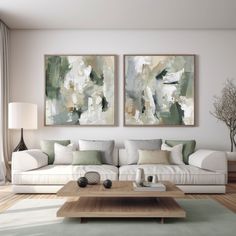 a living room with two paintings on the wall and a coffee table in front of it