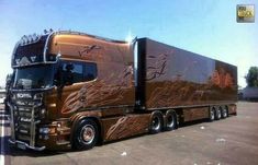 a large semi truck with flames painted on it's side in a parking lot