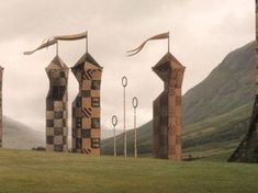 several tall sculptures in the middle of a field