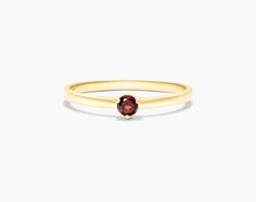 This 1.8mm petite single garnet birthstone ring in 14K yellow gold is a beautiful and elegant piece of jewelry. It is made of high-quality gold and features a small, sparkling garnet gemstone. The ring is also available in a variety of birthstones, so you can choose the perfect one for your loved one. This ring is a great option for stacking with other rings, creating a unique and fashionable look. If you are looking for a stylish and versatile piece of jewelry, then this 14K yellow gold 1.8mm p Petite Rings, Ring Symbolism, Garnet Birthstone, Petite Ring, Garnet Jewelry, Jewelry Diamonds, Diamond Settings, Engagement Ring Styles, Garnet Gemstone