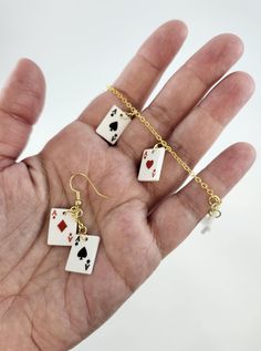 Fun and sophisticated playing card earrings and bracelet. Earrings come in a set of 2 cards per earring (four different cards per set) and 4 cards per earring (four different cards per earring). Bracelet comes with 8 cards, 2 of each. All with gold findings. Two card earrings hang 1.25 inches below earring hook. Four card earrings hang 1.5 inches below earring hook. Bracelet is 8 inches long with lobster claw closure. Card Earrings, Hook Bracelet, Earring Hook, Le Crochet, Playing Card, Lobster Claw, Jewelry Earrings Dangle, Dangle Drop Earrings, Playing Cards