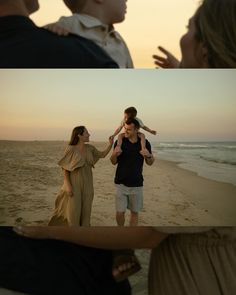 two people are on the beach and one person is holding a child in his arms