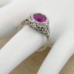 Vintage Estate 2.00 Carat Lab Created Ruby Solitaire Filigree Ring. Floral Designs. 925 Solid Sterling Silver. The Top Of The Ring Measures 3/8 Inches In Length. Set With One 6.5 mm High Quality Lab Created Ruby Stone. Stamped 925. Excellent Condition/Like New. Valentine's Day Classic Birthstone Ring, Classic Ruby Ring For Anniversary On Valentine's Day, Classic Ruby Ring For Anniversary And Valentine's Day, Elegant Ruby Ring For Wedding, Formal Rings With Birthstone For Valentine's Day, Elegant Ruby Birthstone Ring For Anniversary, Classic Pink Birthstone Ring For Formal Occasions, Elegant Birthstone Ring For Valentine's Day, Formal Birthstone Rings For Valentine's Day