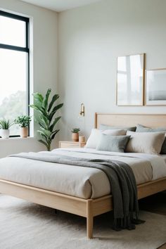 a bedroom with a large bed and potted plants