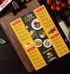 a restaurant menu on a cutting board with tomatoes and other food items around the table