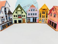 a row of colorful wooden houses sitting next to each other