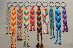 six different colored braided key chains with tassels on each side and one in the middle