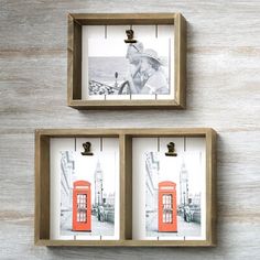 two wooden frames with pictures hanging on them