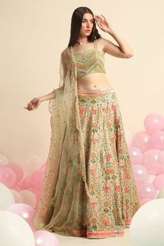 Mint green printed lehenga with neon embroidery in floral motifs. Paired with embroidered blouse and organza dupatta.
Component: 3
Pattern: Embroidered,Printed
Type Of Work: Floral
Neckline: Sweetheart
Sleeve Type: Sleeveless
Fabric: Organza, Dupion Silk
Color: Green
Other Details: 
Floral print
Scallop dupatta
Striped blouse
Occasion: Destination Wedding - Aza Fashions Festive Green Embroidered Lehenga, Unstitched Green Embroidered Lehenga, Unstitched Green Lehenga For Festivals, Green Embroidered Choli For Navratri, Multicolor Organza Choli With Floral Embroidery, Embroidered Green Choli For Navratri, Summer Reception Lehenga With Sheer Dupatta, Summer Reception Lehenga With Dupatta, Embroidered Multicolor Organza Choli