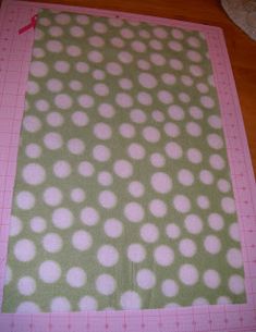 a pink and green mat with white polka dots on it