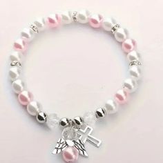 Delicate Angel Wing Cross Charm Bracelet - Exquisite Pink And White Faux Pearls. Adjustable Hypoallergenic White Charm Bracelet, White Adjustable Hypoallergenic Rosary Bracelet, Pink Rosary, Cross Bracelets, Christian Bracelets, Rosary Bracelet, Girly Accessories, Cross Bracelet, Cross Charms