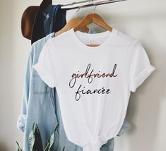 "This t-shirt is everything you've dreamed of and more. It feels soft and lightweight, with the right amount of stretch. It's comfortable and flattering for both men and women. Girlfriend Fiancee Shirt, Future Mrs, I Said Yes, Engagement Shirt, Engagement Gift, Fiance Shirt, Bachelorette Party Shirt, engaged Shirt H O W - T O - O R D E R - Be sure to review the size chart in the photos before making your selection.  - Select your size, color & quantity from the drop-down menus. - Click the \"Add Britney Meme, Married Shirt, Engaged Shirts, Honeymoon Shirts, Bride Shirt, F Scott Fitzgerald, Never Stop Dreaming, Mama T Shirt, Bride Shirts