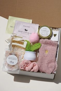 an open box filled with pink items on top of a table