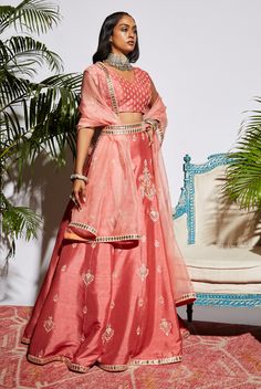 Editor's Note Pink Assorted Butta Lehenga With Blouse And Stripe Dupatta. Color: Pink Fabric: Raw Silk Care: Dry Clean Only About the Designer SVA has been meticulously crafting exquisite Couture creations over the years with a unique imprint with their dexterous workmanship & intricate details. The Brand philosophy resonates with the core ethos of protecting & preserving our rich national legacy of textile & crafts. To empower the grassroots and celebrate the beauty of human craftsmanship. Lehenga With Blouse, Indian Luxury, Sharara Designs, Raw Silk Lehenga, Organza Lehenga, Lehnga Dress, Black Floral Top, Pink Lehenga, Textile Crafts