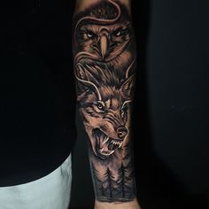 an owl and wolf tattoo on the arm