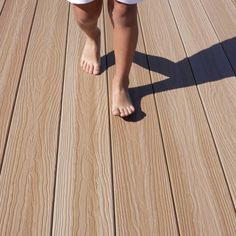 a person standing on top of a wooden deck