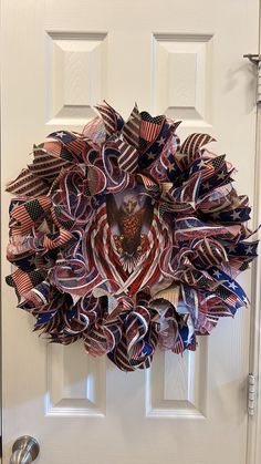 a patriotic wreath hanging on the front door